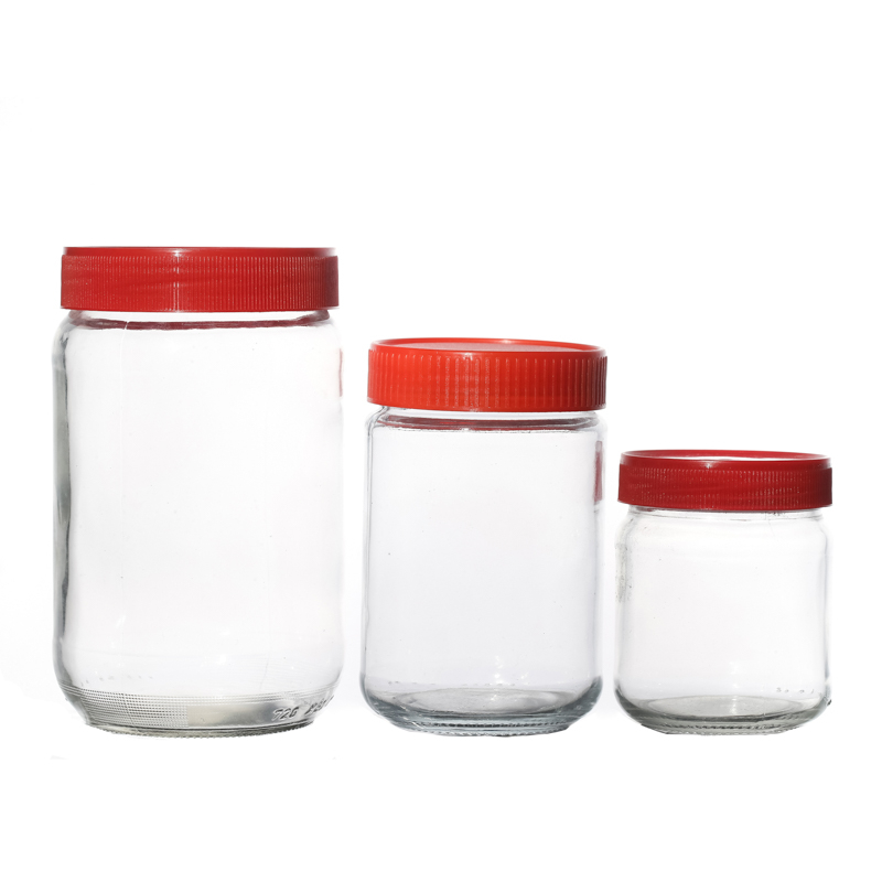 Venta caliente Jarra de vidrio personalizado Bebida para el envasado de alimentos de cristalería con mermelada de miel con tapas rojas de plástico