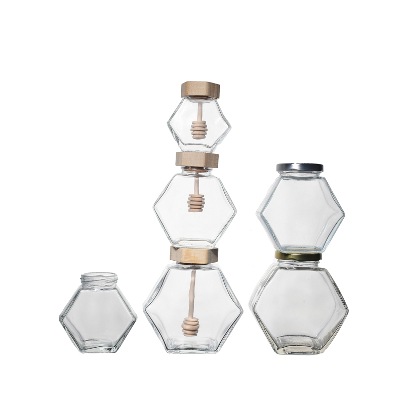 Frascos de miel de vidrio hexagonal de alta calidad con tapas de bambú