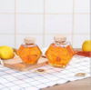 Frascos de miel de vidrio hexagonal de alta calidad con tapas de bambú