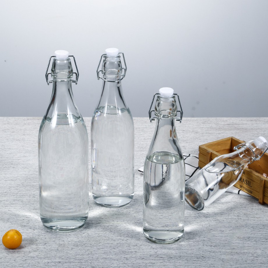 Botellas de vidrio para bebidas al por mayor de 250 ml Botellas de leche de agua con tapas abatibles
